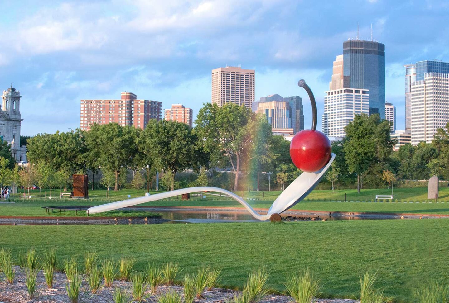 Sculpture of a Spoon with Cherry on it in a garden