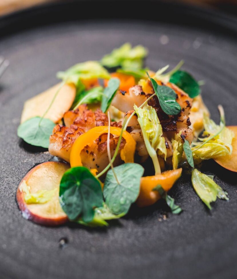 a cooked fish filet garnished with salad